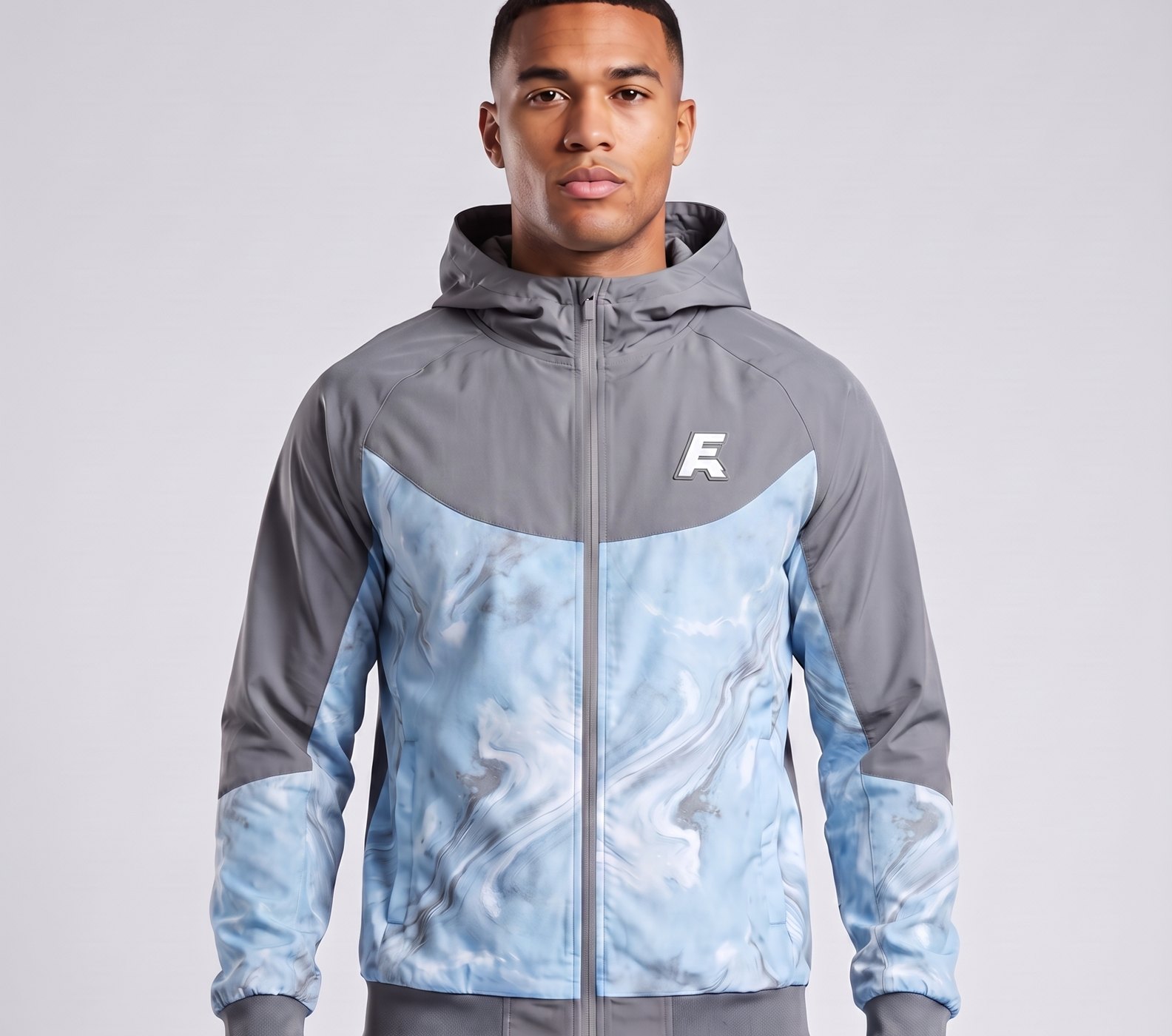 Model wearing the Aurora Marble hooded tracksuit in grey and ice blue